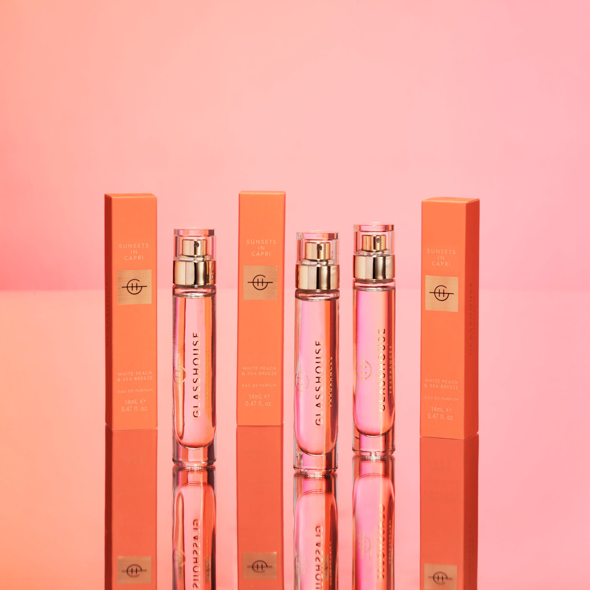 Three bottles and boxes of Sunsets In Capri Eau de Parfum