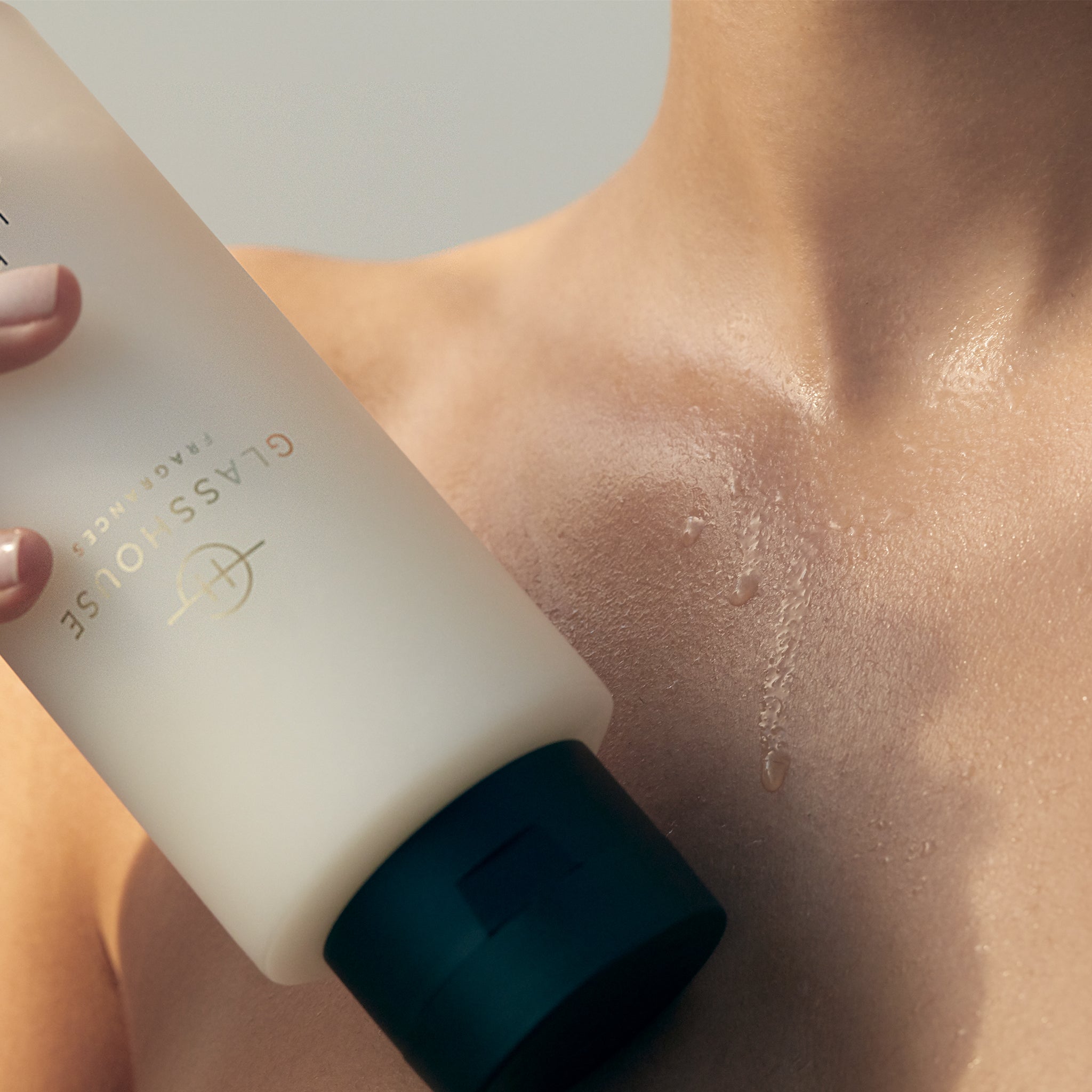 Glasshouse Fragrances Shower Gel held up against bare neck and chest