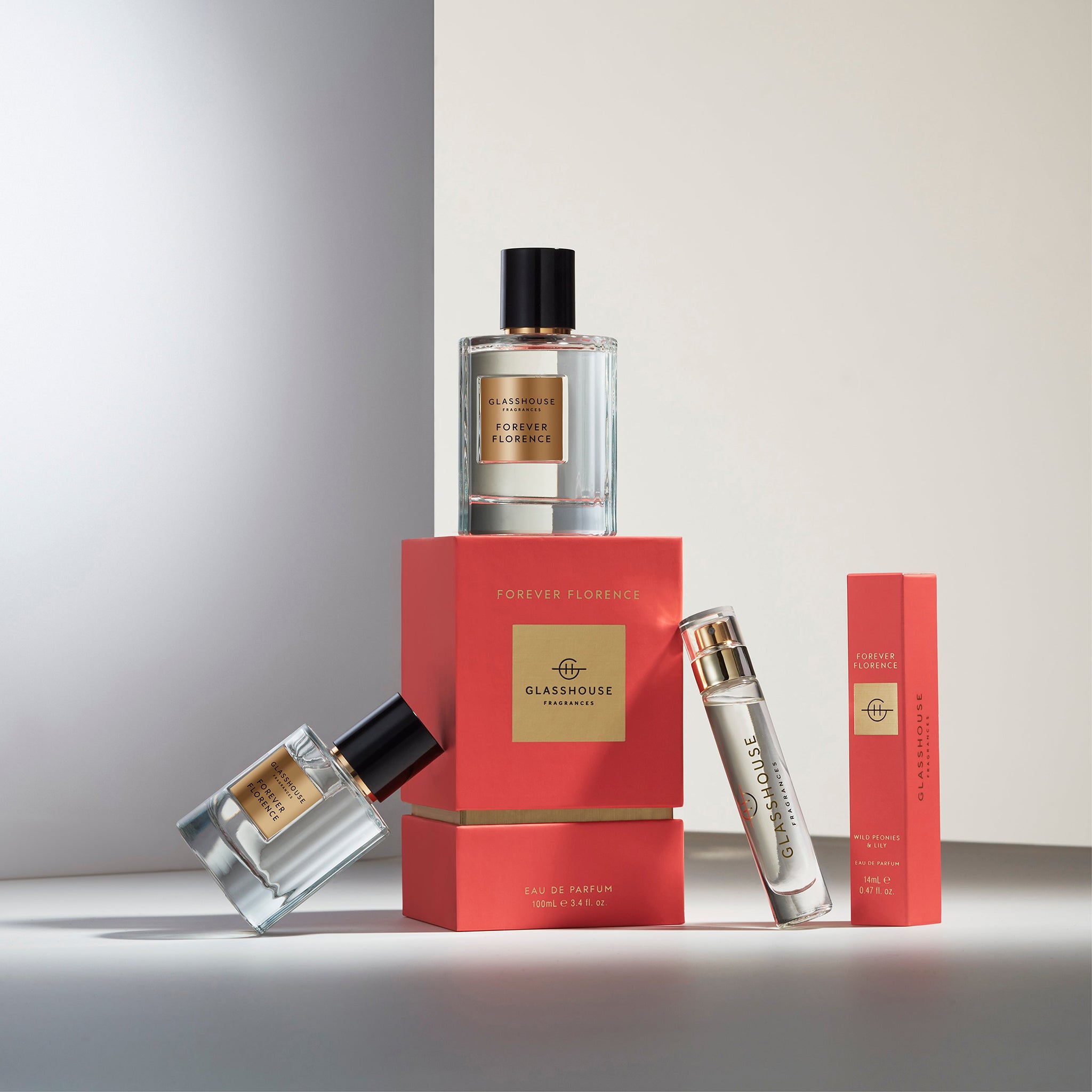 Glasshouse Fragrances Forever Florence Wild Peonies and Lily Various sizes Eau de Parfum with boxes spotlit on white tabletop 