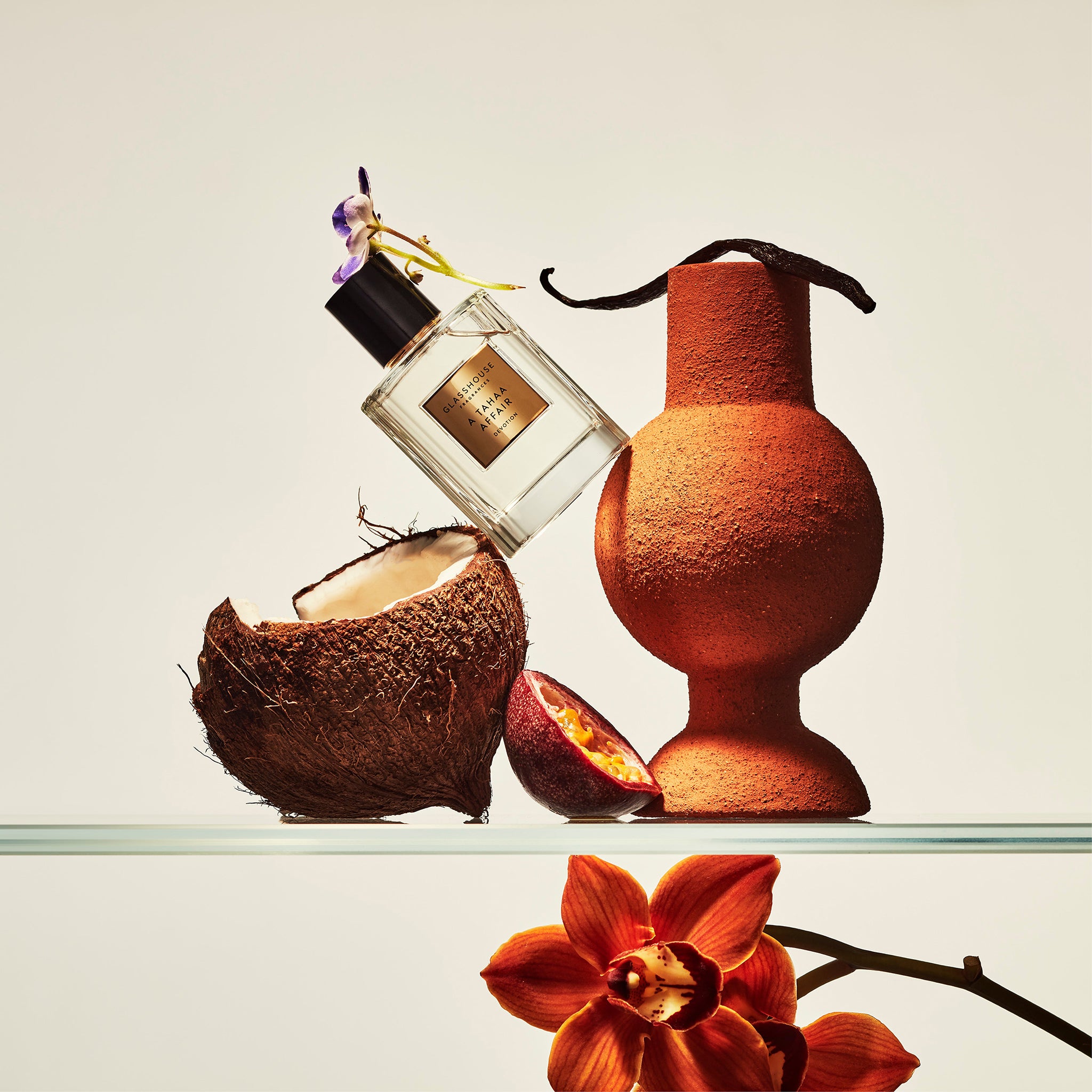 Glasshouse Fragrances A Tahaa Affair Vanilla Caramel Eau de Parfum bottle in a tropical setting 