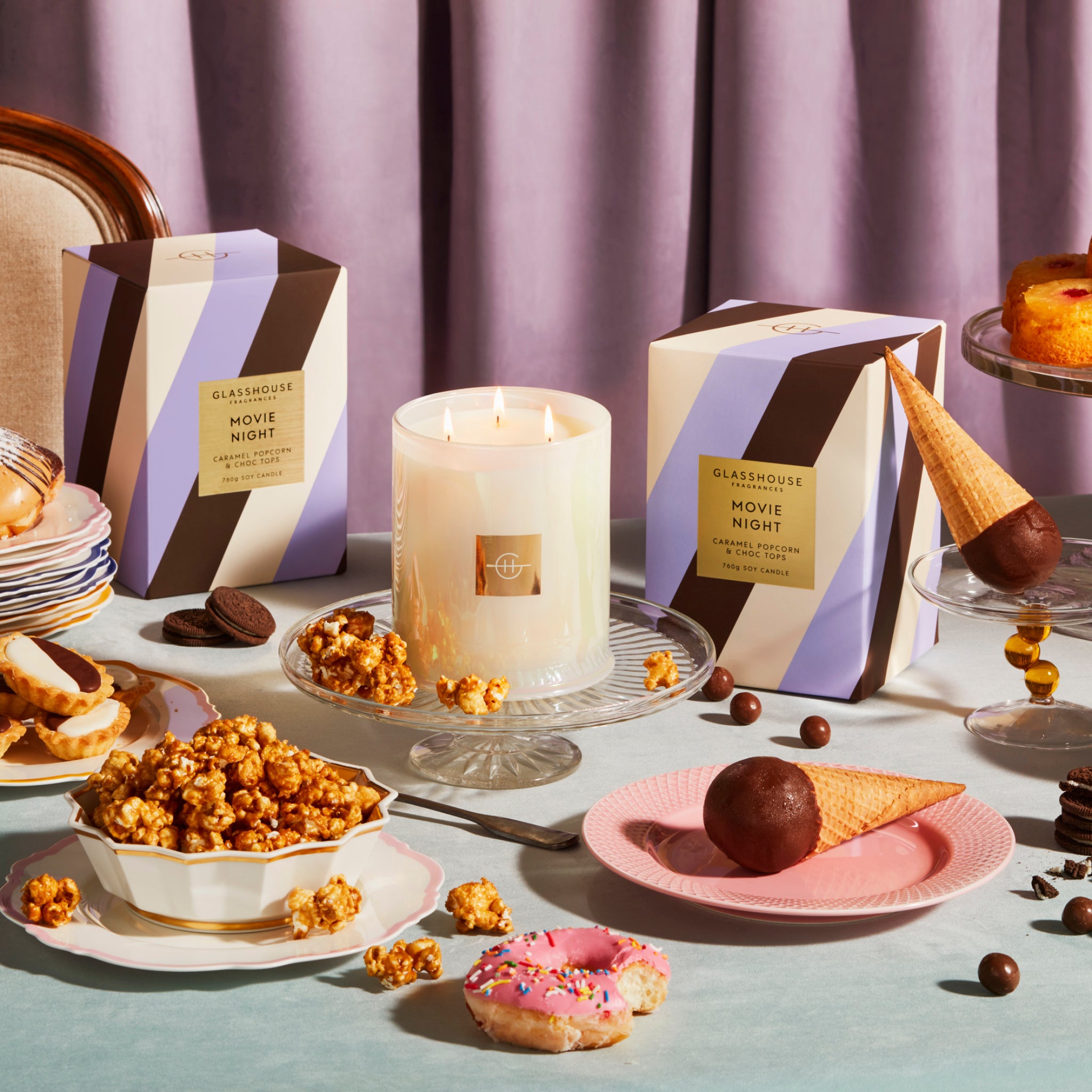 Glasshouse Fragrances Movie Night Popcorn and Choc Tops 380g Soy Candle burning tabletop with choctop, popcorn, sweets