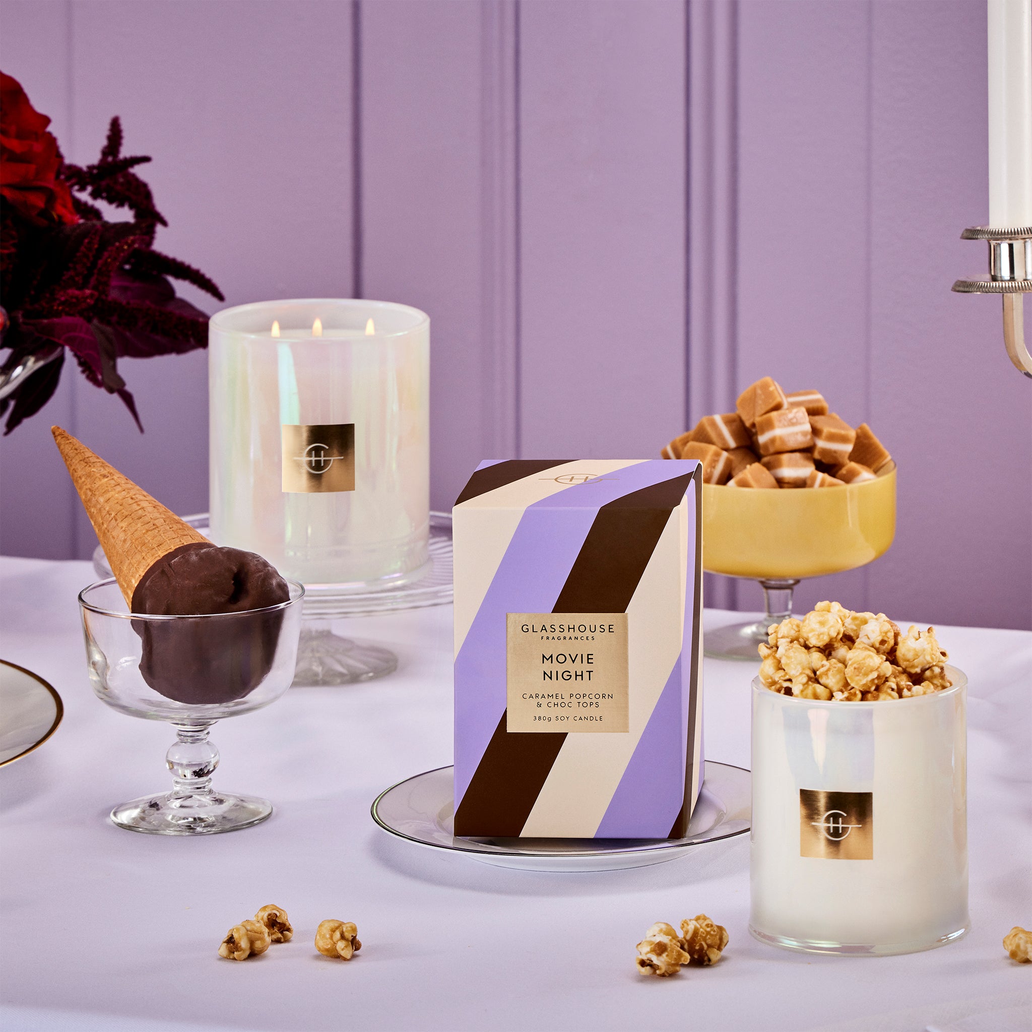 Glasshouse Fragrances Movie Night Popcorn and Choc Tops 380g Soy Candle burning tabletop with choctop, popcorn, sweets